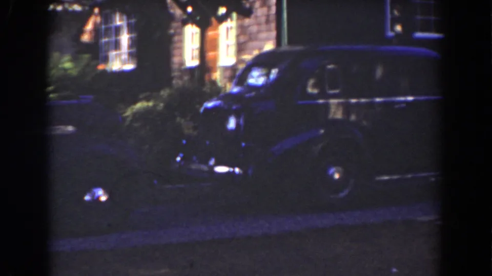The final frame holds on the dark automobile, its chrome details catching light beneath warm residential windows in the 1939 Mount Washington clip.