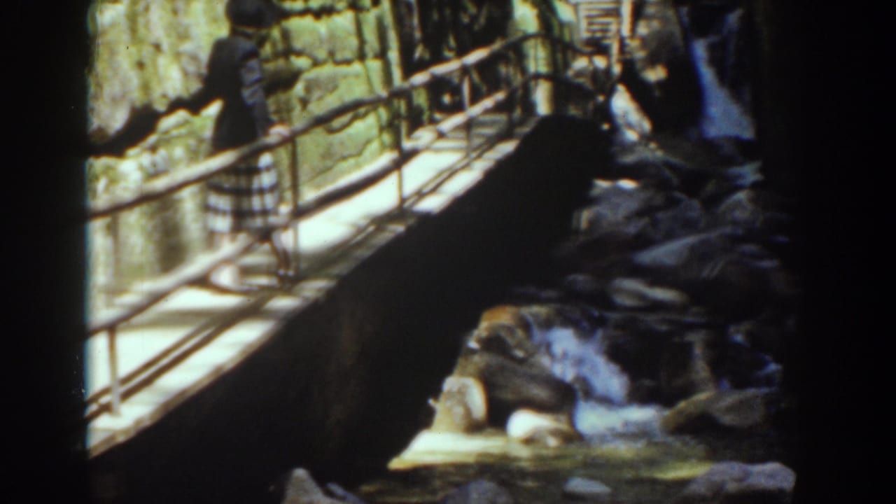 The visitor remains on the bridge as water moves through rocks below in this 1939 Mount Washington home-movie view.