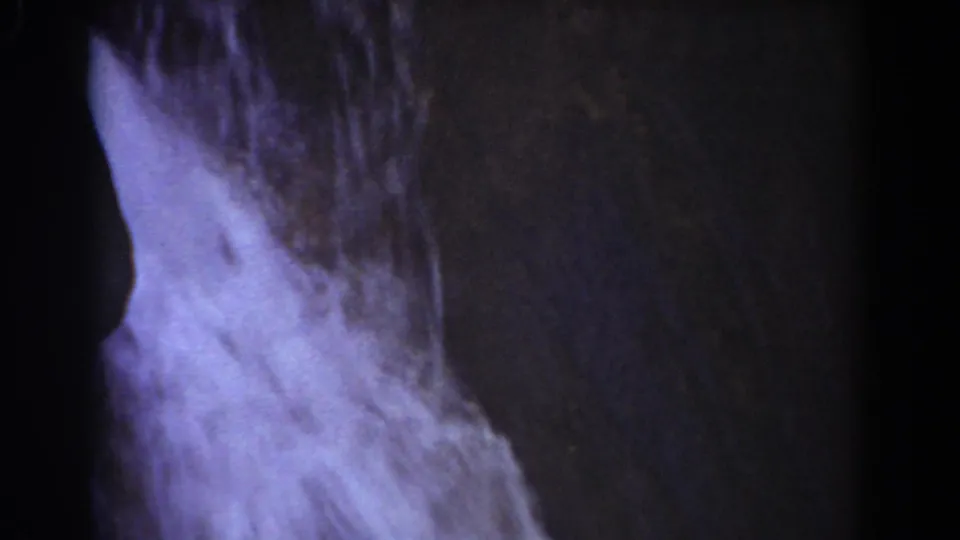 Close waterfall detail from 1939 Mount Washington footage, with pale water spreading over rough stone.