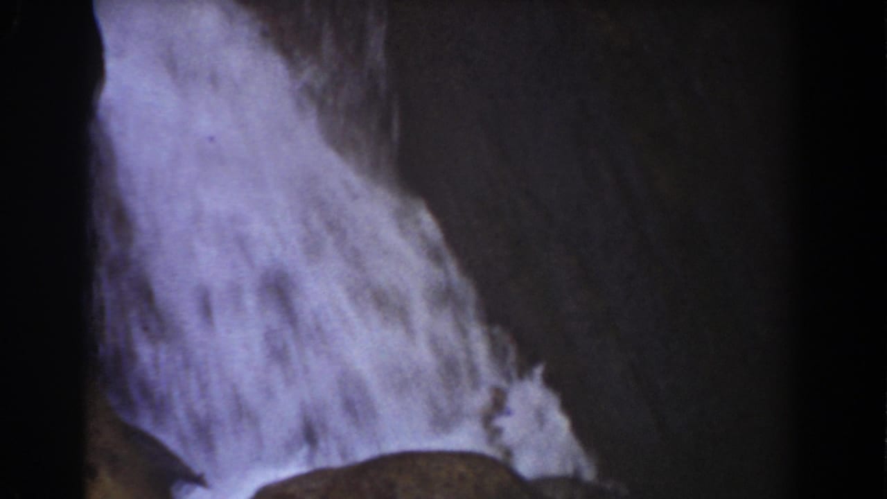 Late-1930s 8mm frame of water pouring over slanted rock at Mount Washington, New Hampshire.