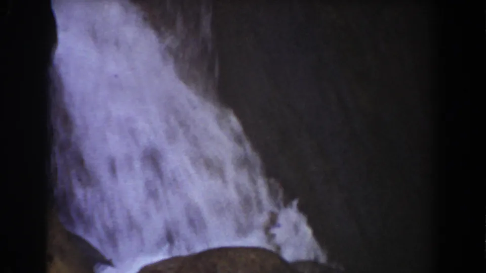 Late-1930s 8mm frame of water pouring over slanted rock at Mount Washington, New Hampshire.