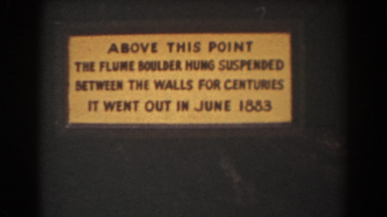 A yellow interpretive plaque about the Flume Boulder is filmed in close-up during the 1939 New Hampshire visit.