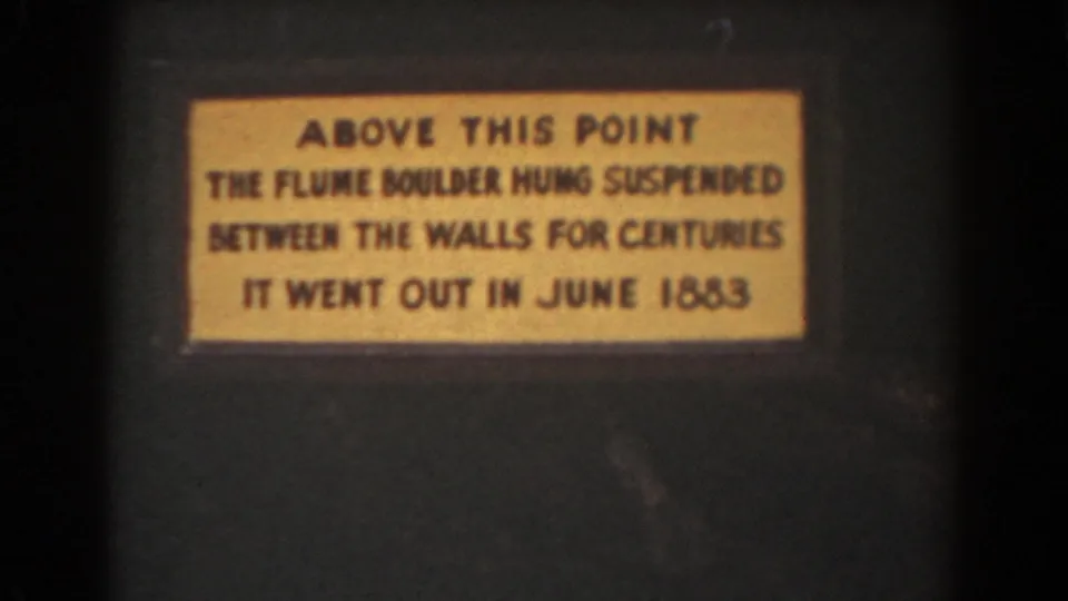 A yellow interpretive plaque about the Flume Boulder is filmed in close-up during the 1939 New Hampshire visit.
