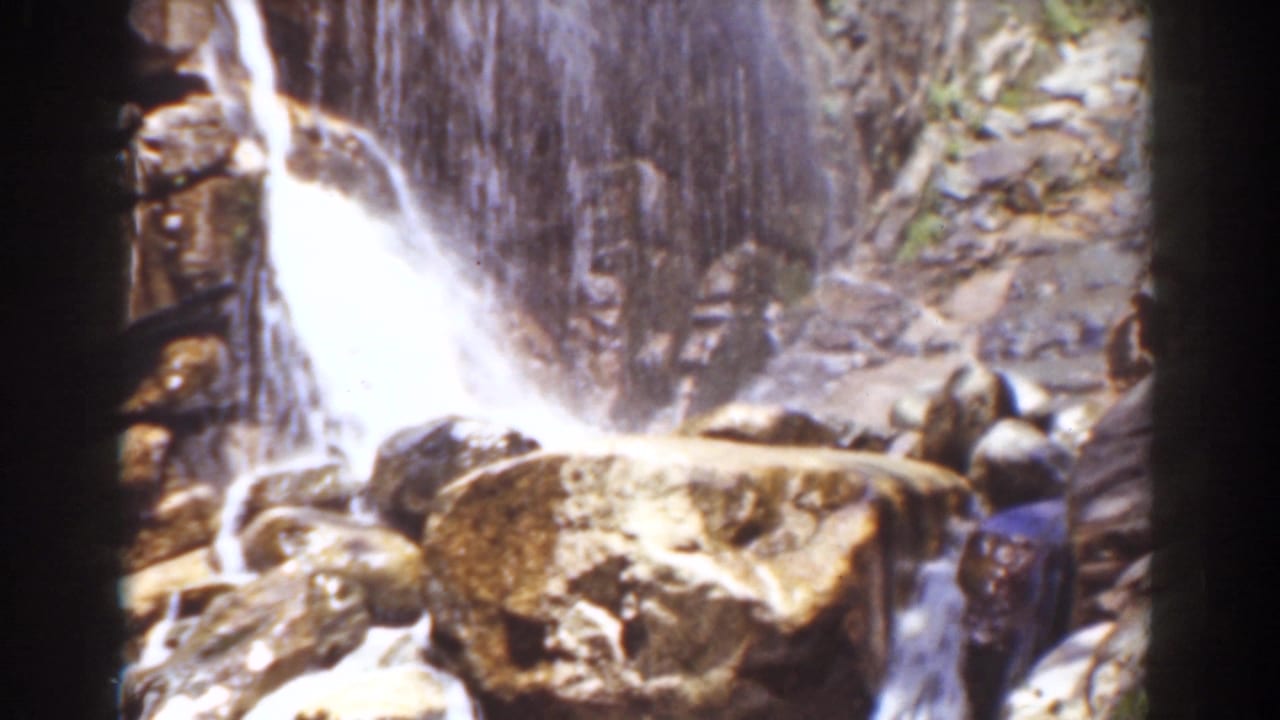 A waterfall cascades over rugged rocks in 1939 Mount Washington home-movie footage.