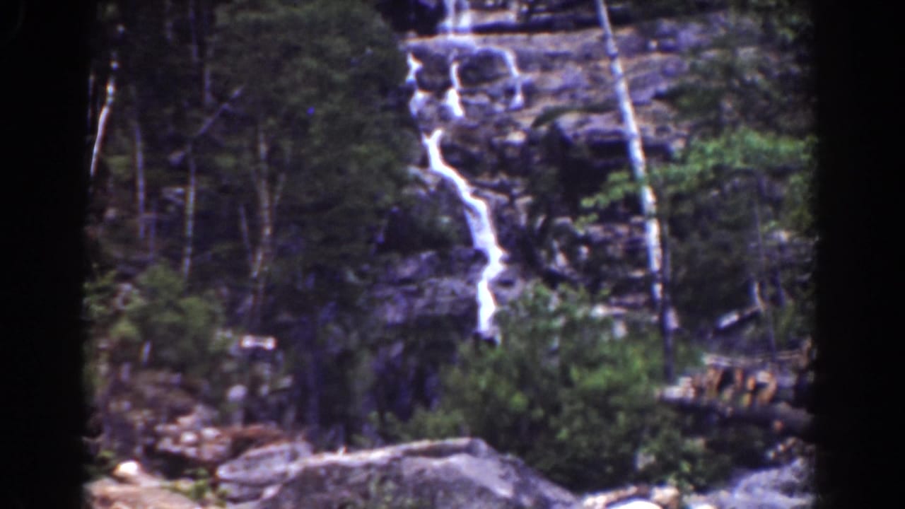 Final 1939 Mount Washington frame showing the cascade, wooded cliff, and rough foreground debris near the stream bed.