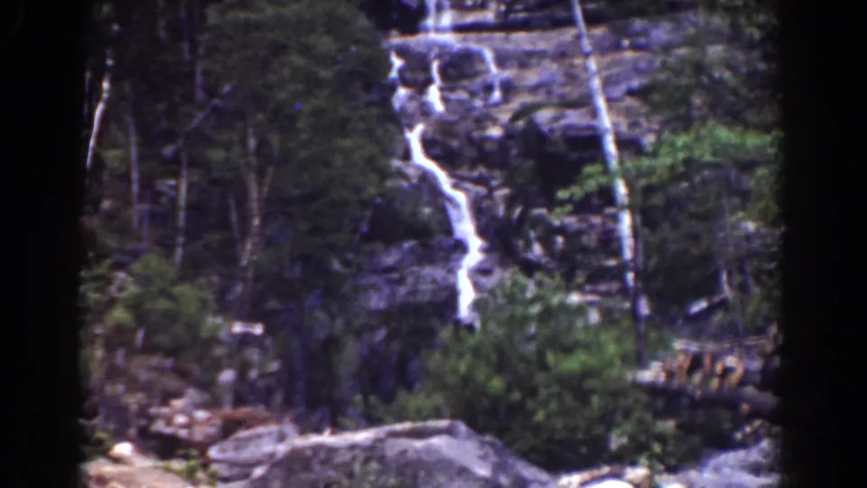 Final 1939 Mount Washington frame showing the cascade, wooded cliff, and rough foreground debris near the stream bed.