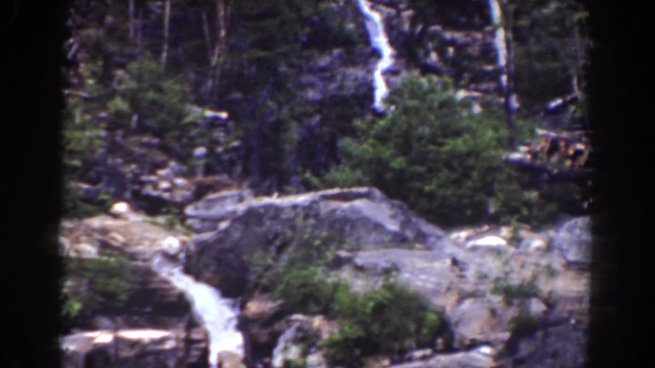 Mount Washington waterfall footage from 1939, with water running over rocks between forest growth and dark 8mm frame edges.