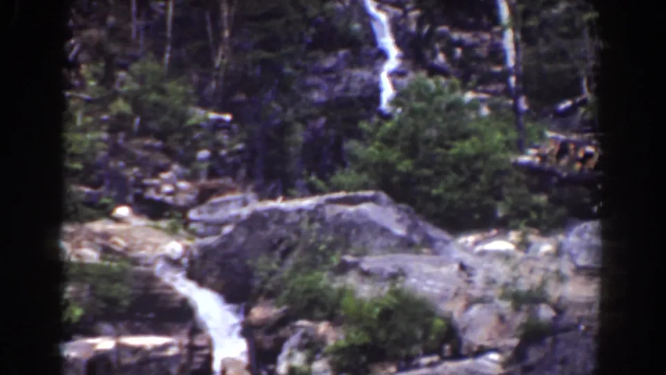 Mount Washington waterfall footage from 1939, with water running over rocks between forest growth and dark 8mm frame edges.