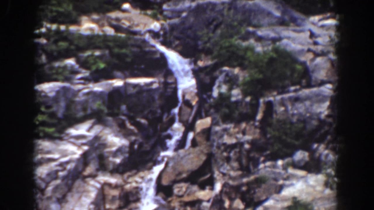 Mount Washington-area waterfall descending through a rocky slope in vintage 8mm home-movie footage.