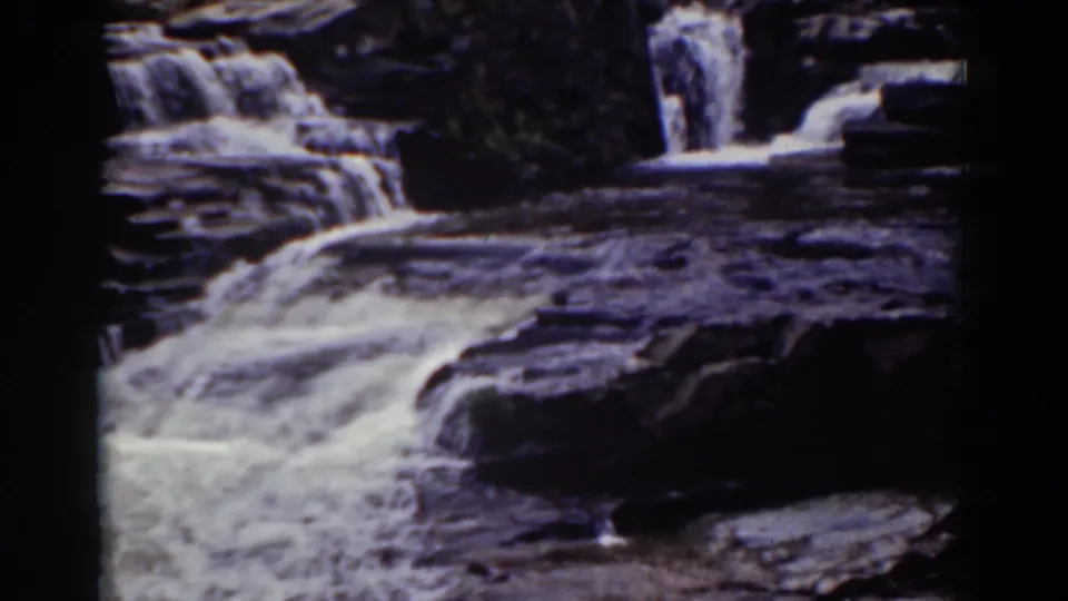 A steady 8mm view of Mount Washington water spilling over broad, dark stone shelves in 1939.