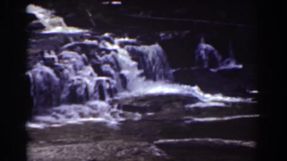 Final 8mm frame of the Mount Washington waterfall, with white water spreading across dark rock shelves.