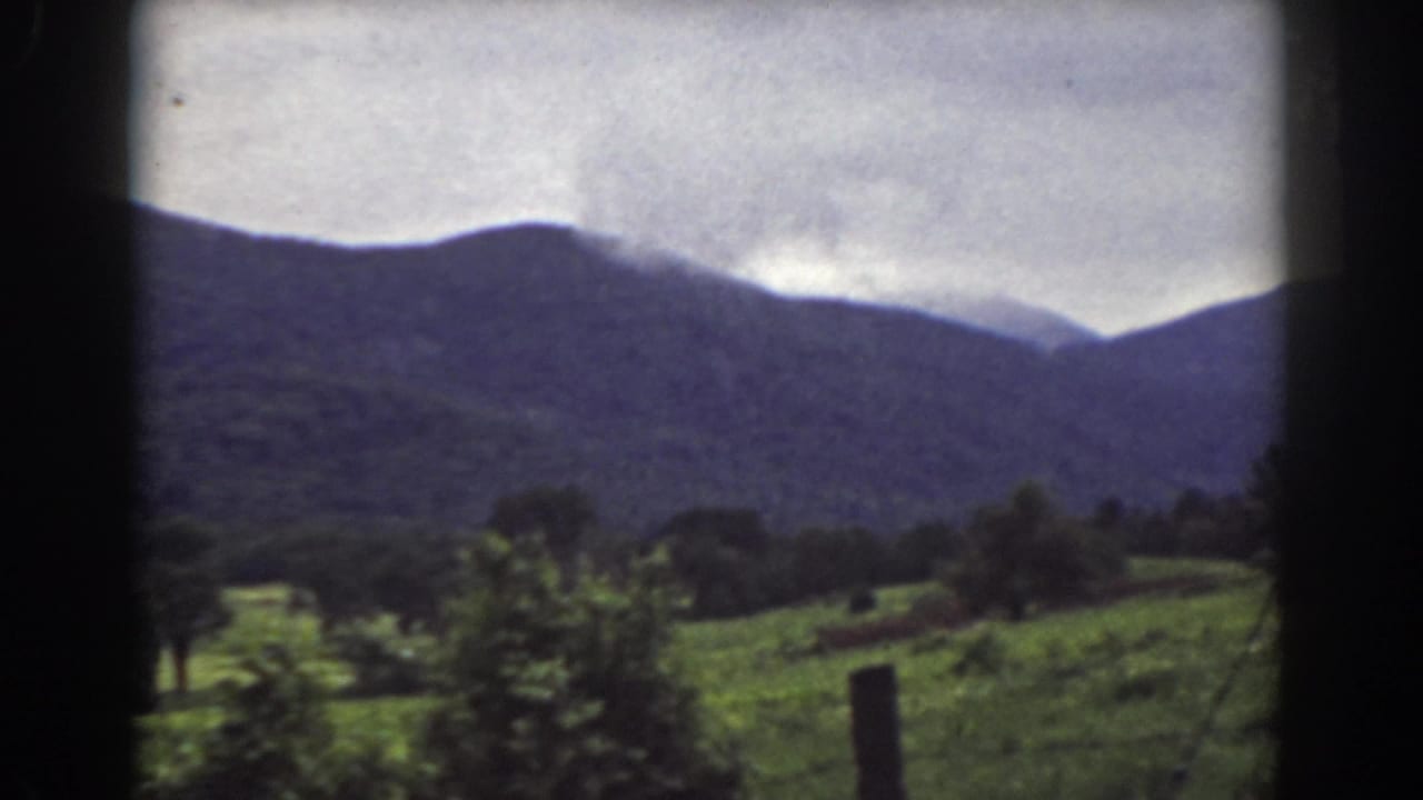 Mount Washington, New Hampshire landscape with green fields, scattered trees, and a dark ridge filmed on 8mm in 1939.