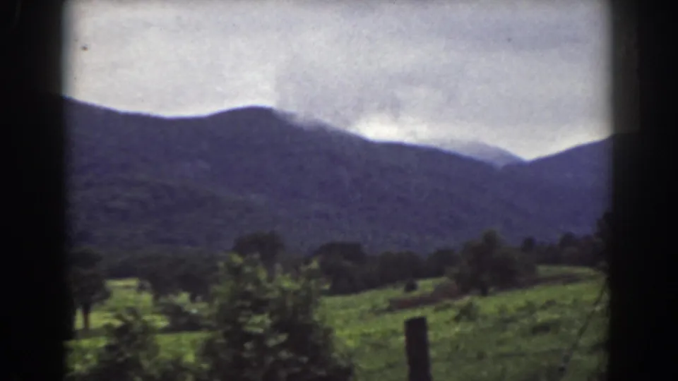 Mount Washington, New Hampshire landscape with green fields, scattered trees, and a dark ridge filmed on 8mm in 1939.