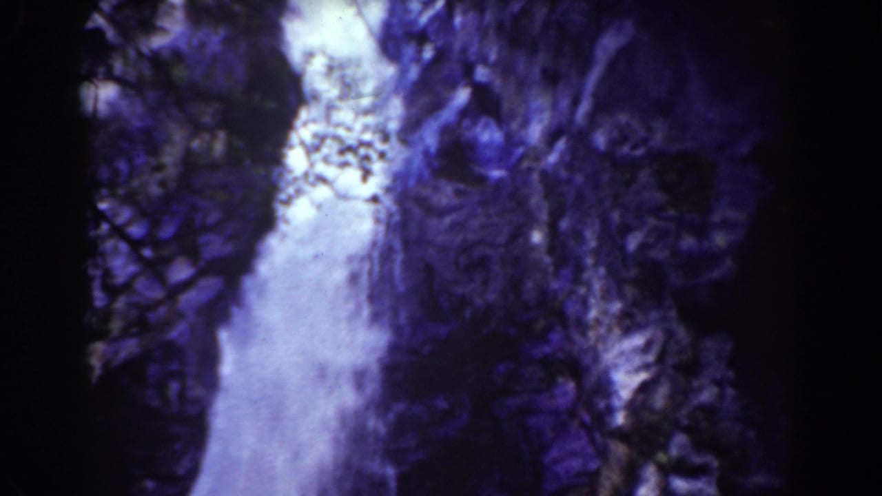 Mount Washington waterfall seen in aged 8mm color, with water pouring past rough cliff surfaces.