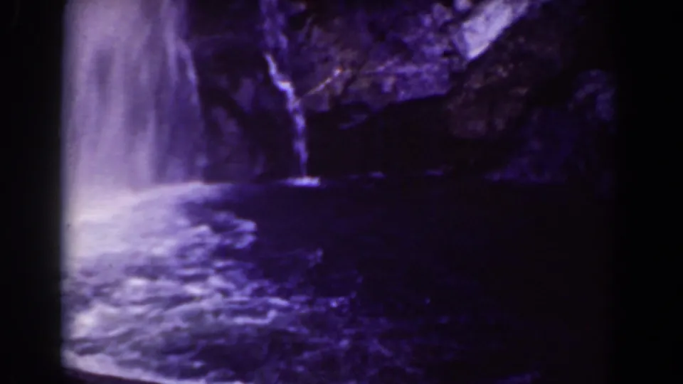 1939 Mount Washington home-movie frame showing the main waterfall, a smaller trickle, and rippled water below.