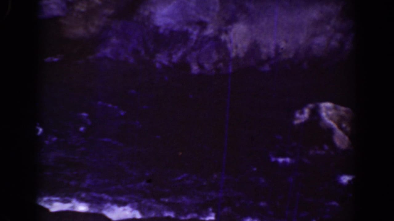 Dark rocky streambed with water and shadowed stones in blue-purple 8mm color.