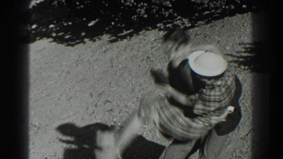 The woman jumps toward the man, her skirt blurred by motion as he catches her in the 1939 San Francisco footage.