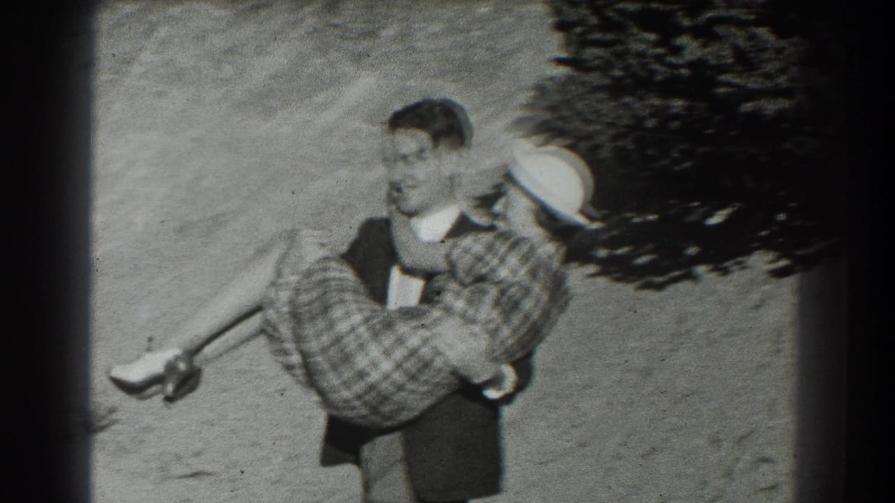 Man carries a woman in a plaid skirt and white hat on a sunny dirt hillside.