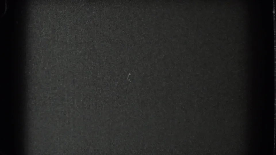 The final frame is largely dark and grainy, showing film texture with no clearly identifiable people or objects.