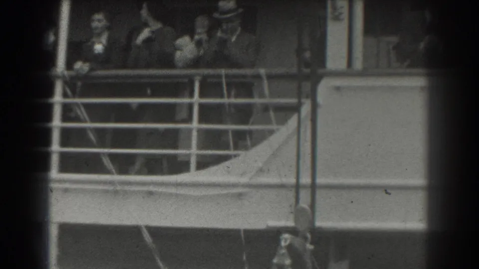A central passenger appears to gesture among others on a ship deck in supported 1939 San Francisco 8mm footage.