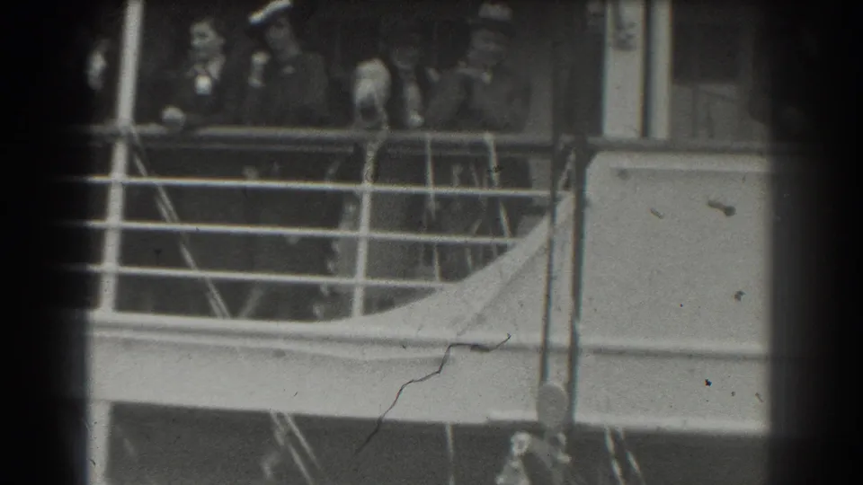 1939 San Francisco home-movie frame showing a ship deck railing with distant passengers partly obscured by the film frame.