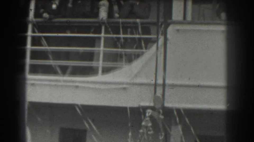 A 1939 San Francisco shipboard view shows railings, cabin structure, and distant figures partly hidden by the frame.
