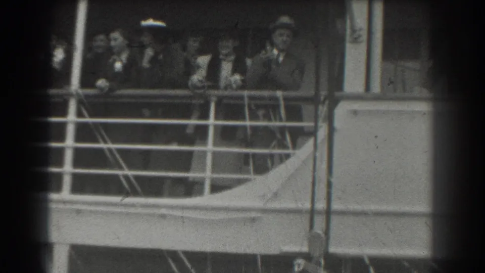 The 1939 home-movie frame shows formally dressed passengers clustered at a San Francisco ship railing during a farewell moment.