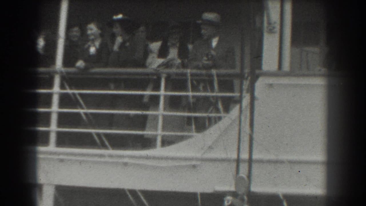 1939 San Francisco home-movie frame showing passengers in hats and coats gathered along a ship deck railing.