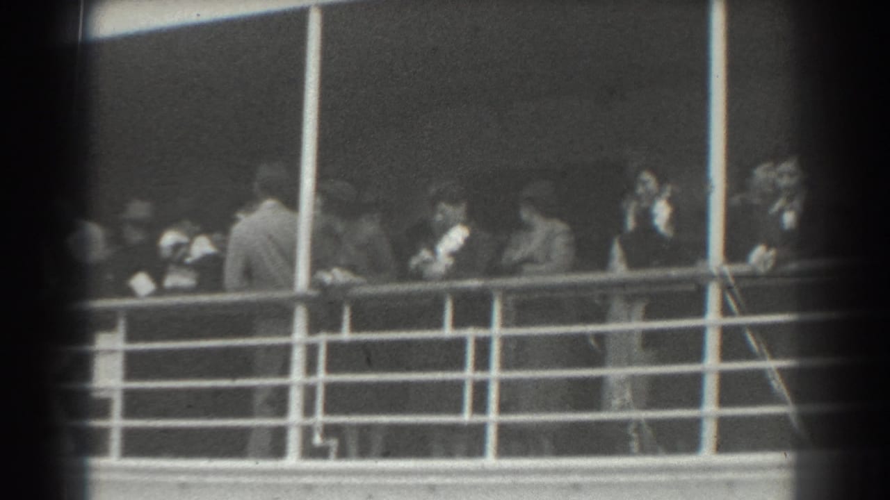 Well-dressed adults on a ship deck in San Francisco, 1939, seen behind railings in grainy black-and-white 8mm footage.