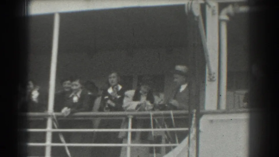 Passengers in late-1930s formal attire appear along a vessel railing in San Francisco archival home-movie footage.