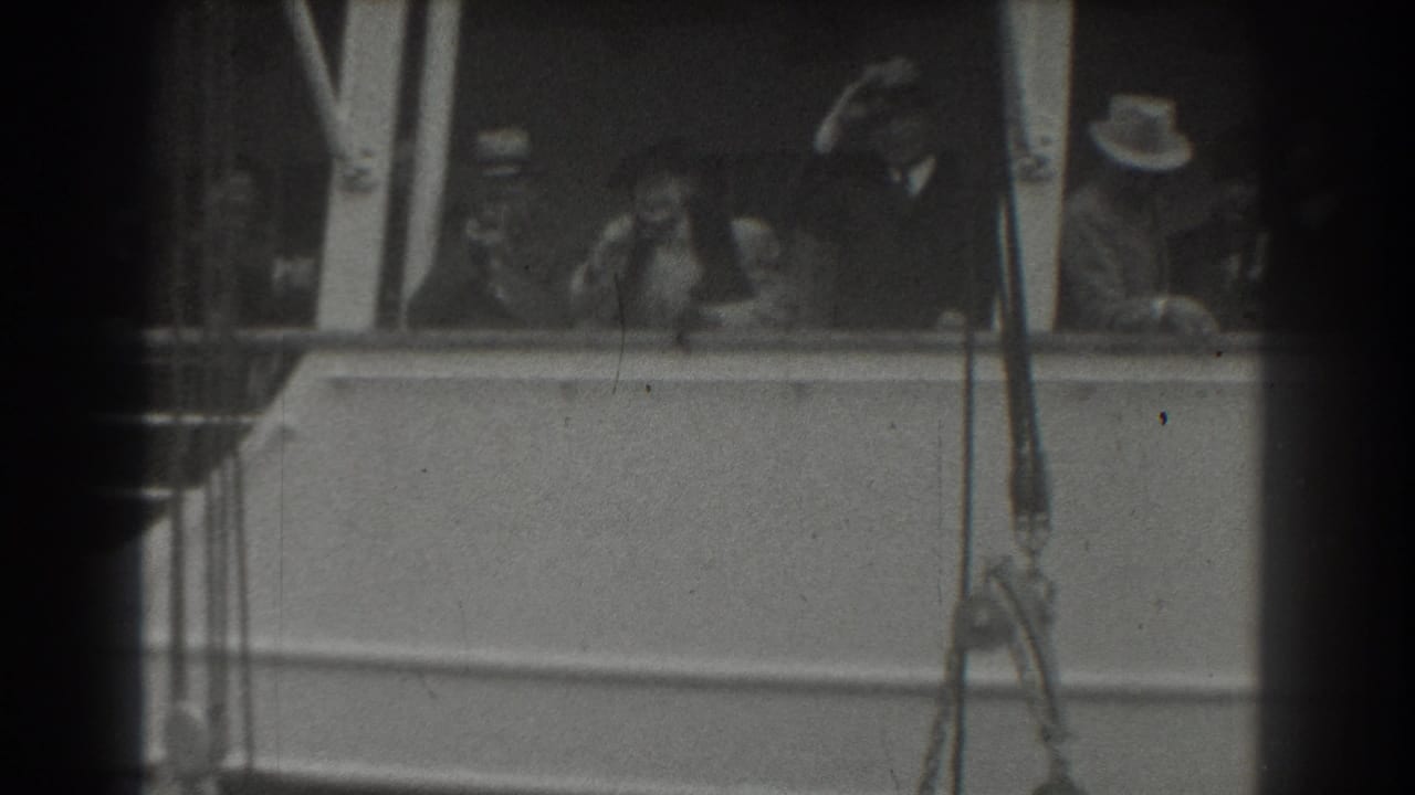 1939 San Francisco home-movie frame showing passengers on a ship deck, including men in hats and a woman near the rail.