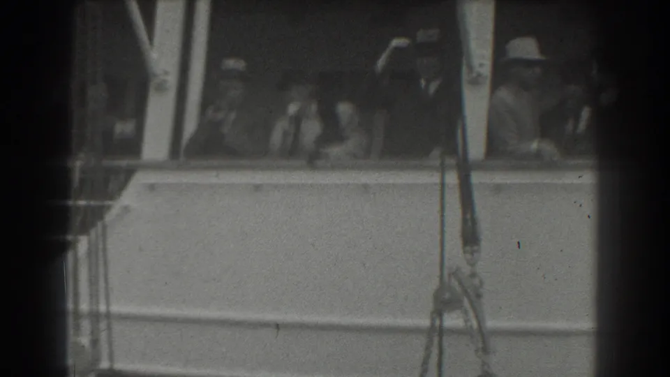 1939 San Francisco home-movie view of ship passengers at the rail, partly obscured by dark 8mm frame edges.
