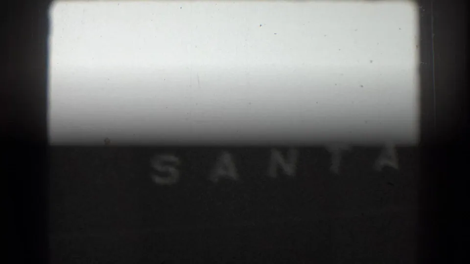 8mm frame with the partial vessel name SANTA on the ship side, obscured by exposure flare and dark gate edges.