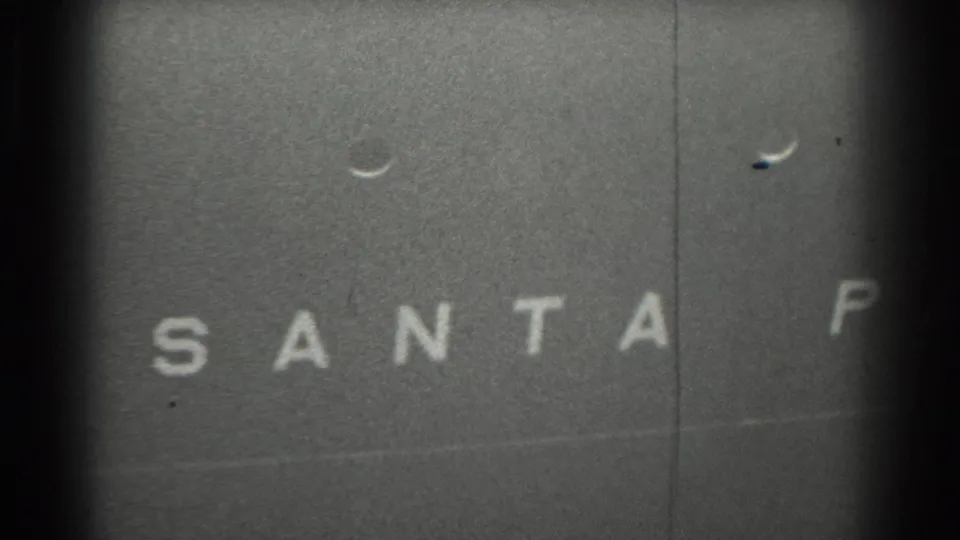 1939 San Francisco 8mm frame showing white block letters from the name Santa Paul on a dark vessel surface.