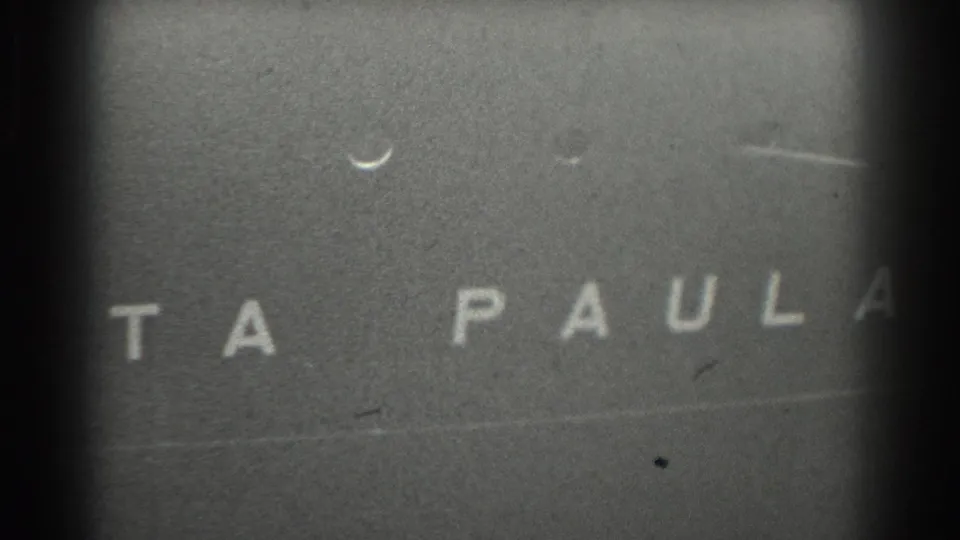 1939 San Francisco 8mm frame showing cropped vessel lettering ending in PAULA on a dark textured surface.