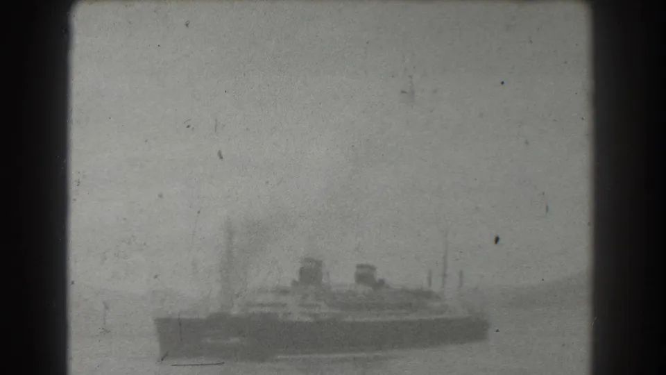A soft black-and-white 8mm view shows the large ship lower in frame on hazy bay water, likely in the San Francisco area per metadata.