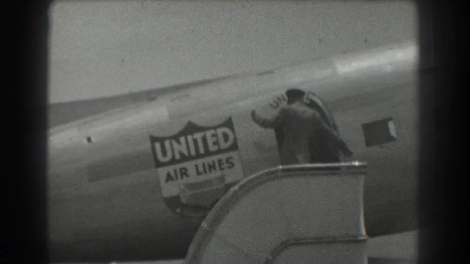 1939 San Francisco frame showing a person at the stair landing next to the United Air Lines aircraft fuselage.