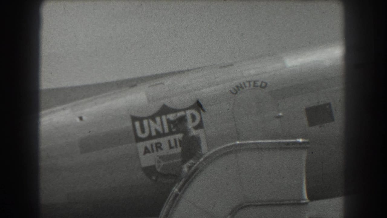 United Air Lines fuselage and passenger stairs, with the exiting man mostly obscured.