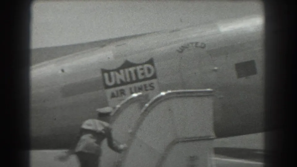 Near the end of the 1939 clip, the passenger moves below the aircraft stairs while the United Air Lines logo stays in view.