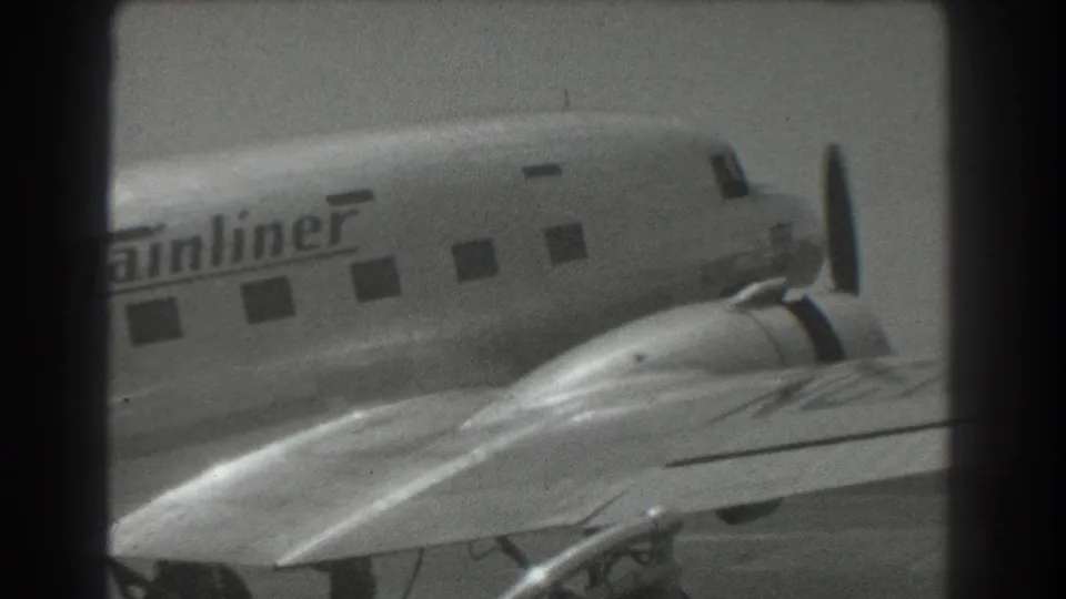 1939 San Francisco frame showing the aircraft nose, propeller, cabin windows, wing surface, and partial Mainliner lettering.