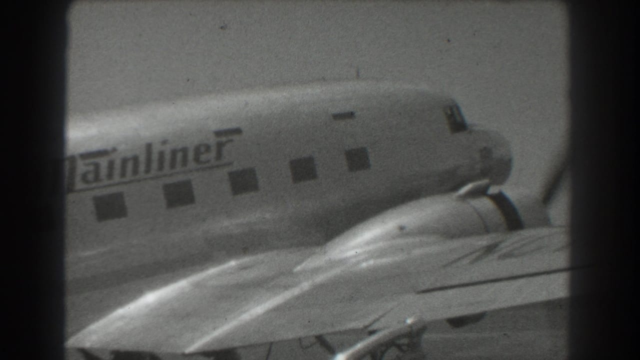 Propeller airliner nose and wing with Mainliner lettering partly visible.