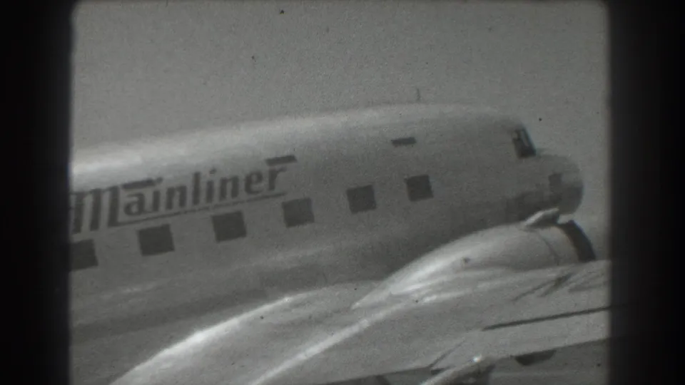 1939 San Francisco home-movie view of the Mainliner-marked airliner, with the fuselage, windows, wing, and engine area visible.