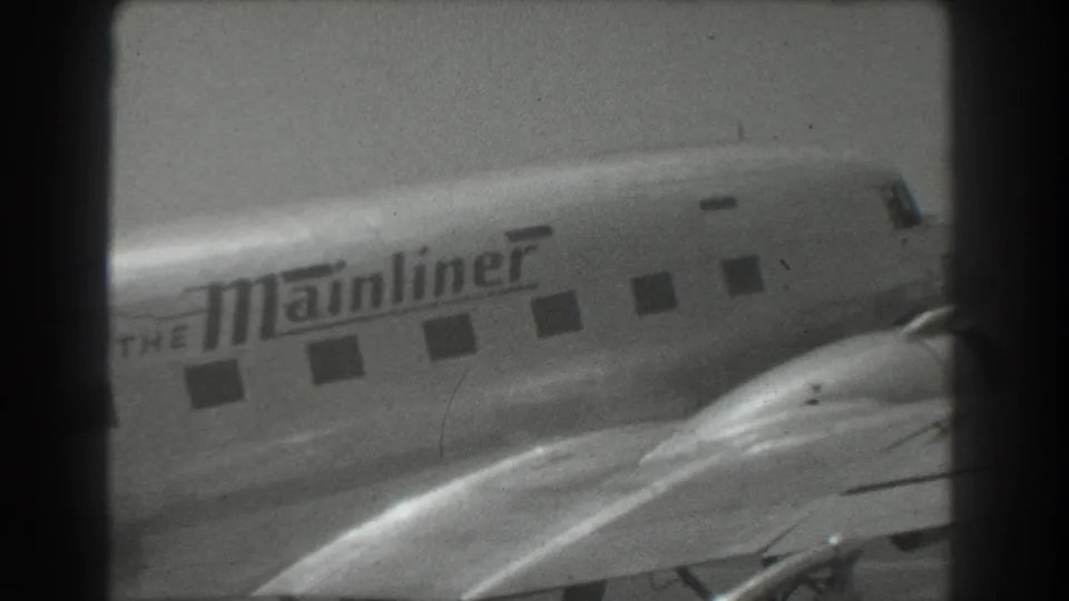 A close 1939 San Francisco frame shows The Mainliner branding, cockpit area, passenger windows, and wing surface on a propeller airliner.