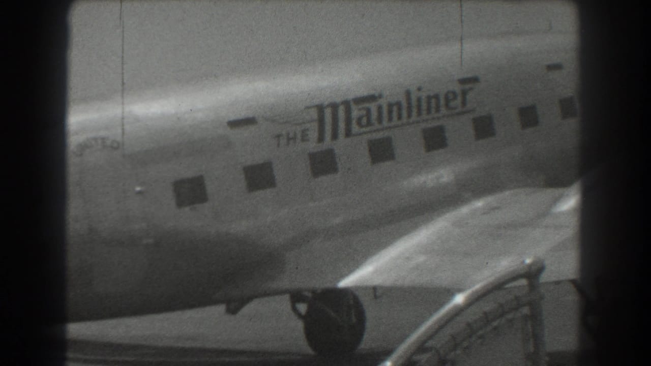 1939 San Francisco footage shows a United Airlines Mainliner aircraft fuselage with passenger windows and foreground equipment.