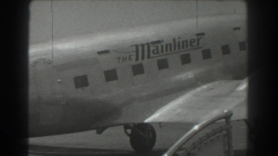 1939 San Francisco footage shows a United Airlines Mainliner aircraft fuselage with passenger windows and foreground equipment.