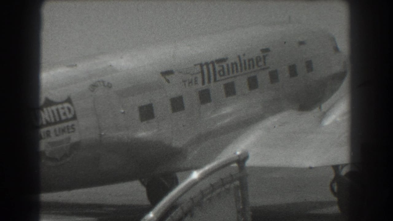 1939 San Francisco airport footage showing a United Air Lines DC-3 Mainliner taxiing past a railing in black-and-white 8mm.