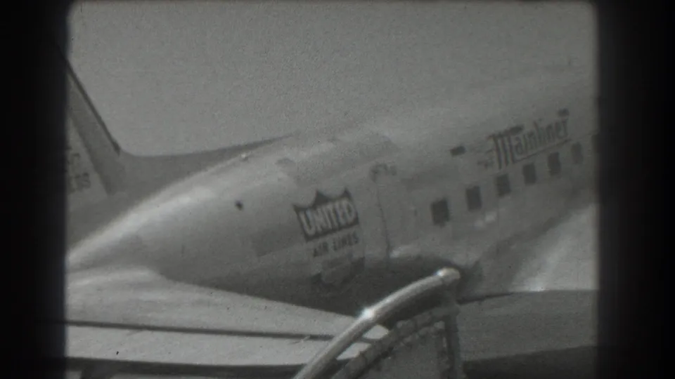 United Air Lines DC-3 Mainliner taxiing in 1939 San Francisco airport footage, seen in soft black-and-white 8mm detail.