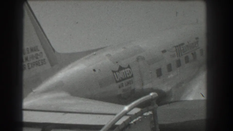 1939 San Francisco home-movie frame showing the rear of a United Air Lines DC-3 with tail and fuselage markings.