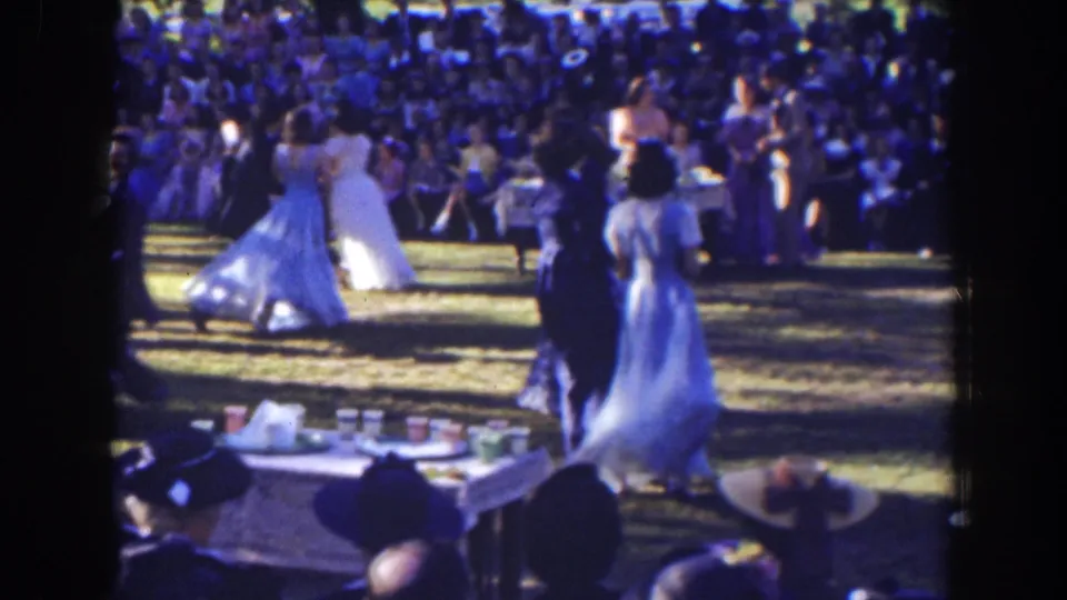 The home-movie frame shows formal dancers on a Florida lawn in 1941, with full skirts, suits, spectators, hats, and tables visible.