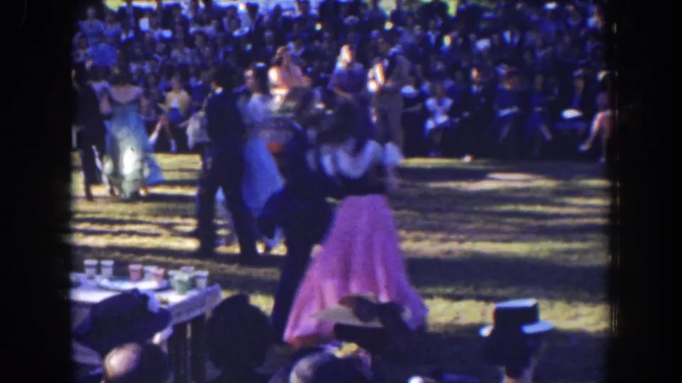 Near the end of the clip, a formally dressed couple dances on grass in 1941 Florida footage, with a large audience and tables behind them.